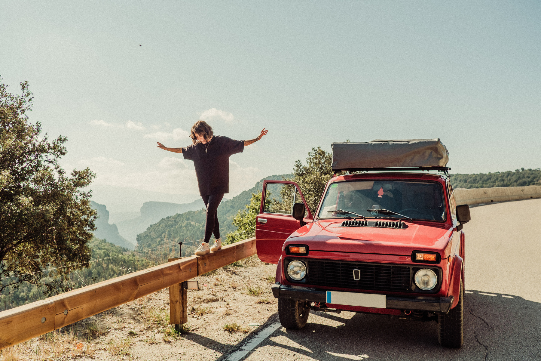 Woman with Red Camper Van on the Road